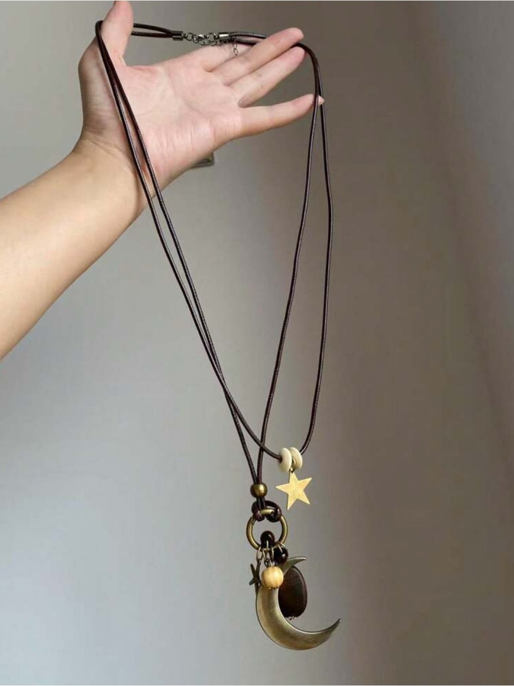 Brown cord necklace with gold moon and star charms
